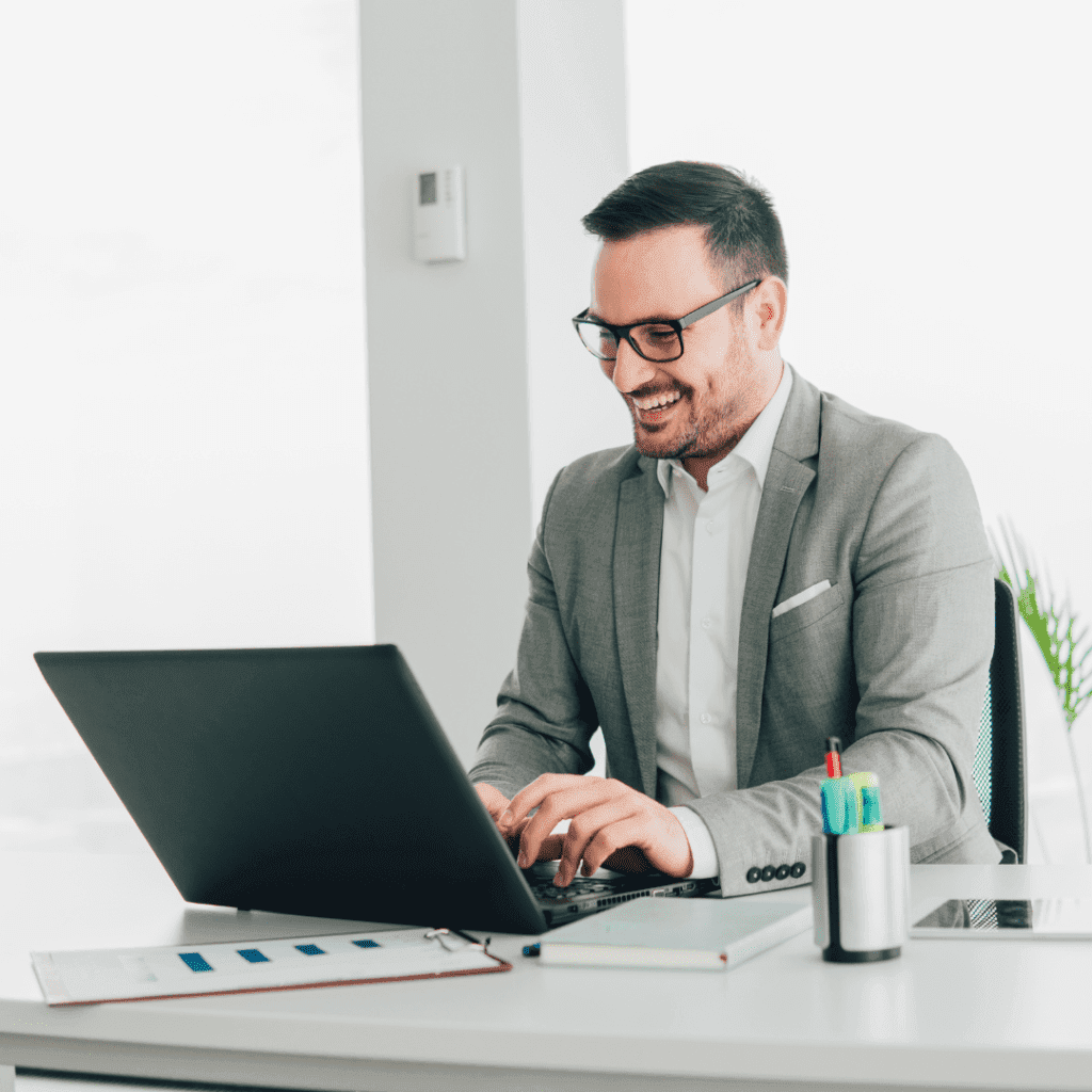 middle age man smiling at laptop