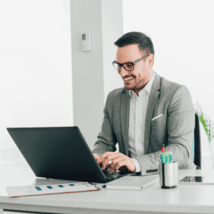 middle age man smiling at laptop