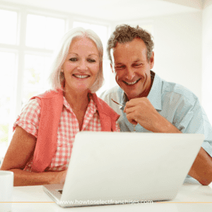a middle age married couple in front of laptop